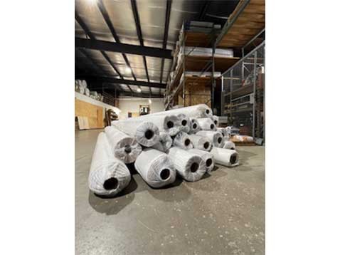 Rolls of fabric in a warehouse